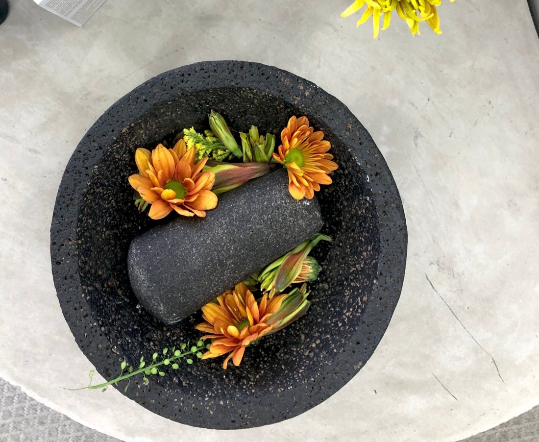 Fresh flowers resting in a stone molcajete
